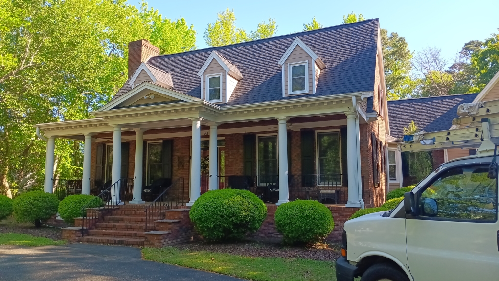 Freshly painted charcoal exterior wall with crisp white trim