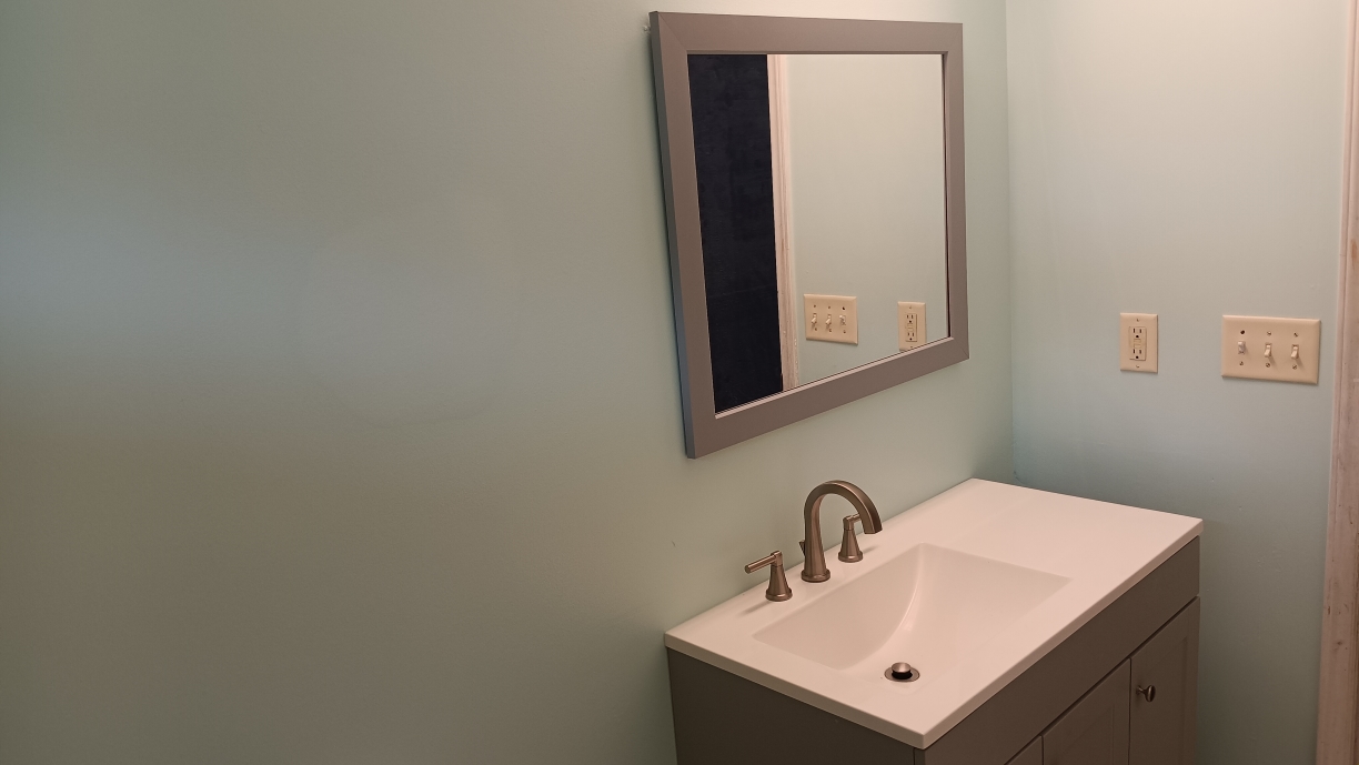 Freshly painted charcoal exterior wall with crisp white trim