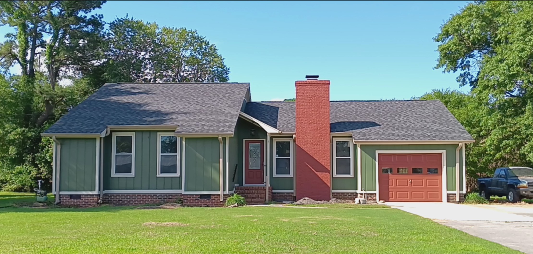 Freshly painted charcoal exterior wall with crisp white trim