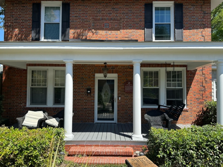 Freshly painted charcoal exterior wall with crisp white trim